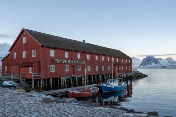 Red timber warehouse housing the Polar Museum along the Tromsø waterfront